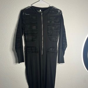 Black bodysuit never worn. Zipper works perfectly no rips no tears.